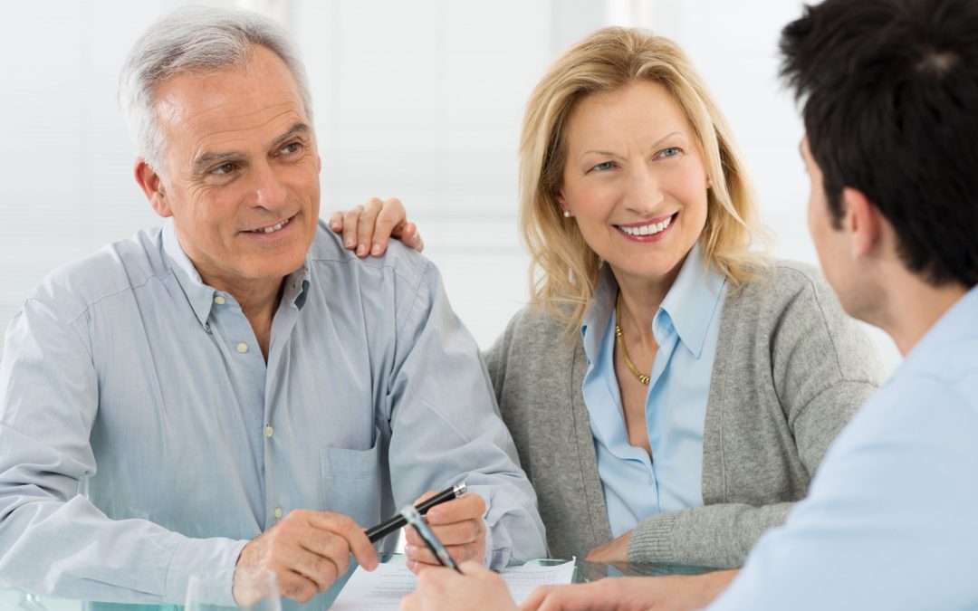 An older adult couple talking to a consultant about their supplemental executive retirement plan (SERP).