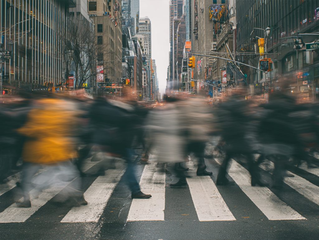 photo of a crosswalk blurred with people to show lots of traffic
