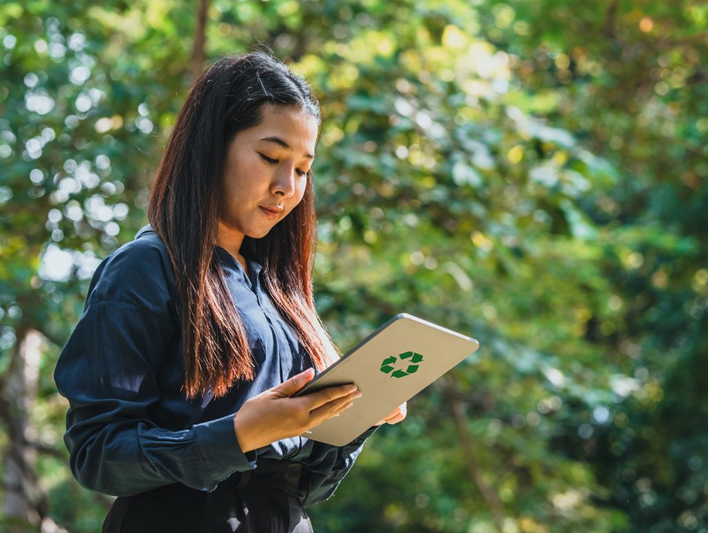 woman reading her ipad in a forest