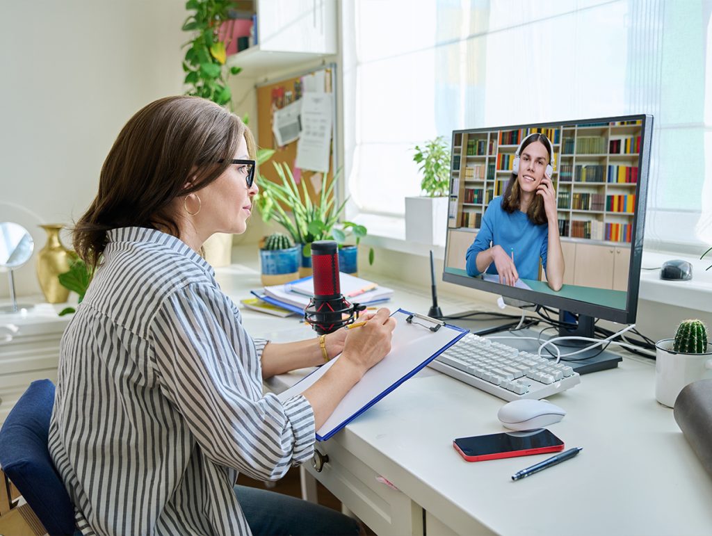a therapist talking with their patient online through a video chat