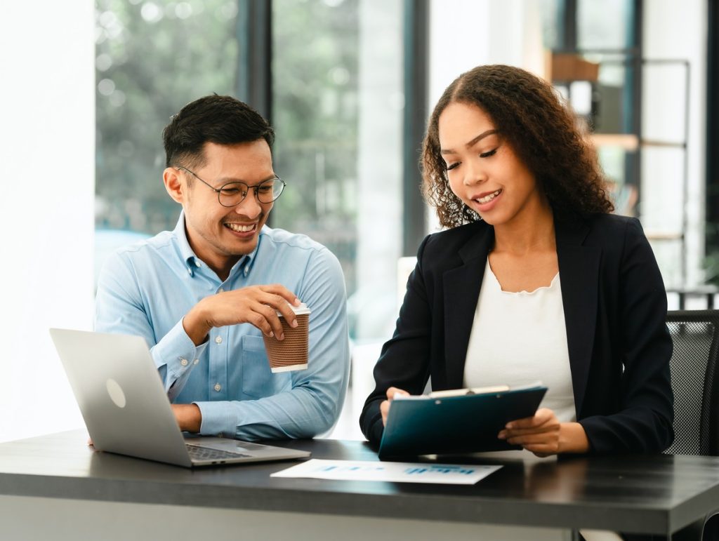 young professional reviewing their portfolio with a financial advisor