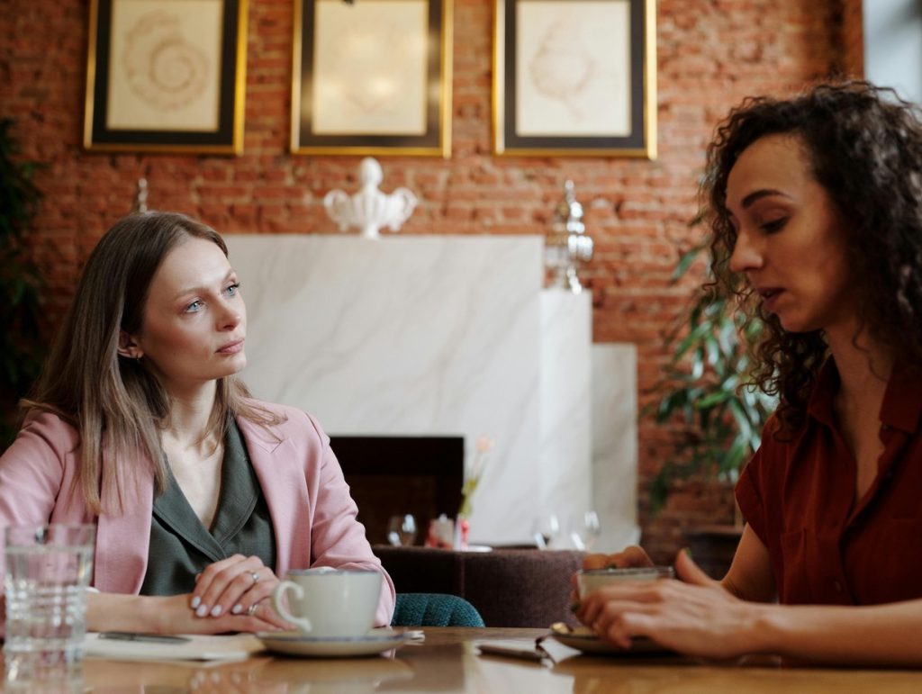employees discussing something over a cup of coffee