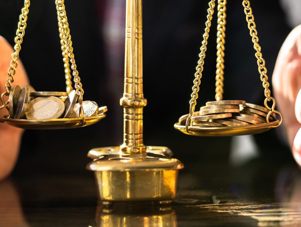 golden scale with moneyattempting at blanace 