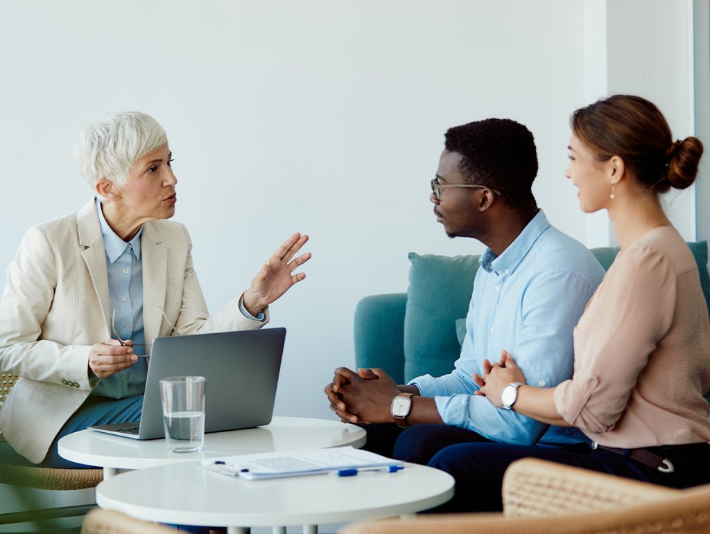 young professional couple meeting with a financial advisor