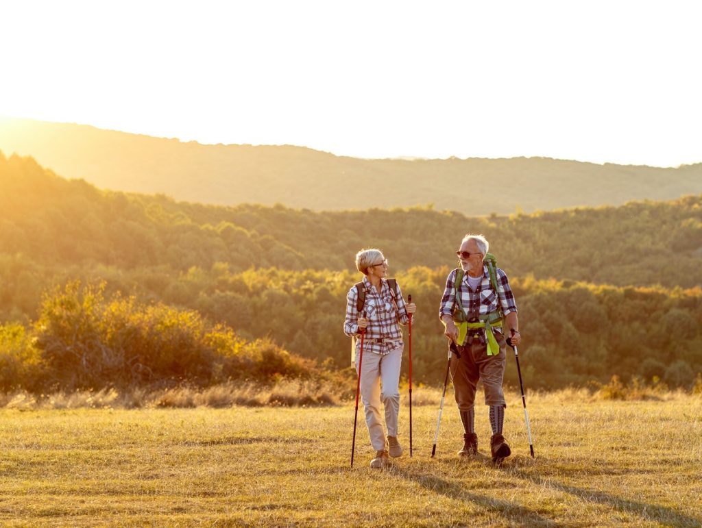 retired couple hiking during sunrise