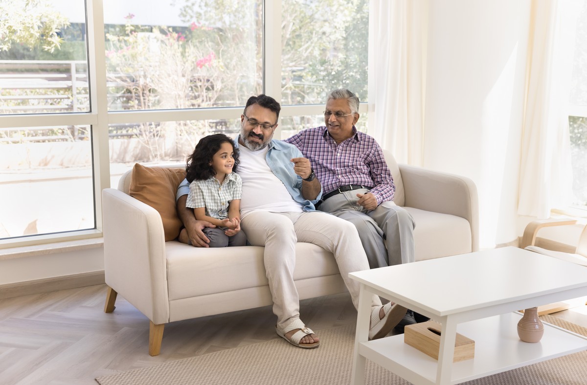 Happy Indian elderly great grandpa and great granddad watching granddaughter Happy Indian elderly great grandpa and great granddad watching granddaughter