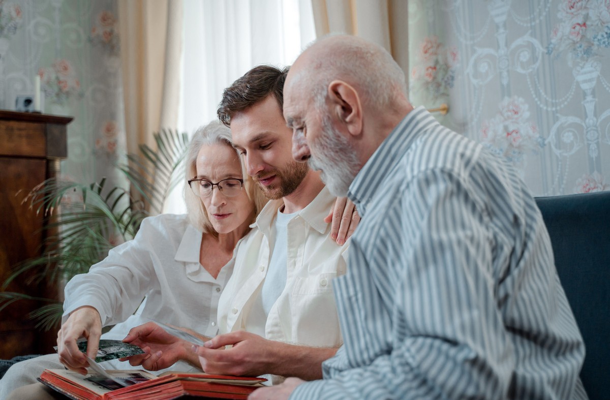 aging-parents-feat_2 elderly parents going through photos and memories with son